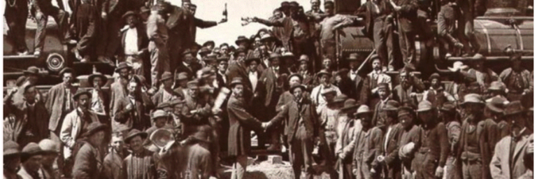 Union Pacific and Central Pacific locomotives meet at Promontory Summit, Utah, on May 10, 1869, as workers and officials celebrate completion of the first transcontinental railroad.